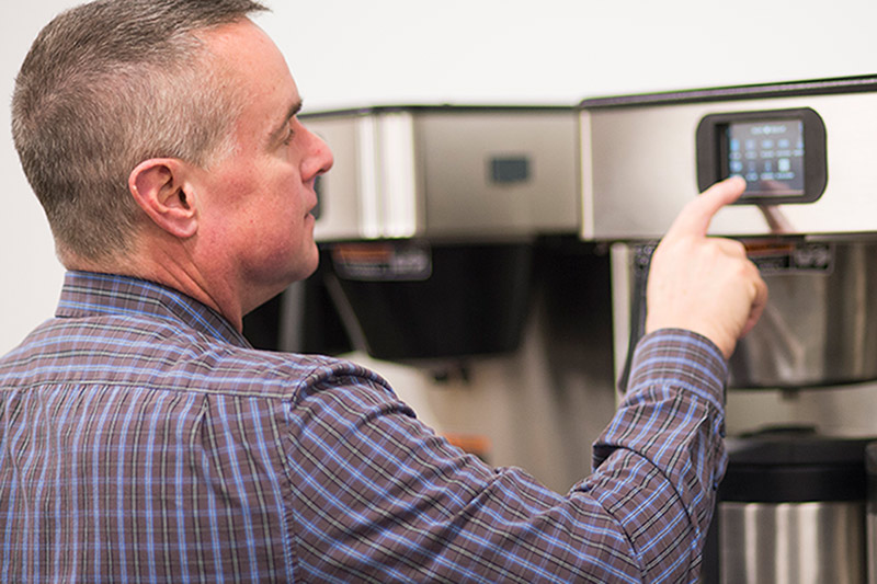 person using a iced coffee machine